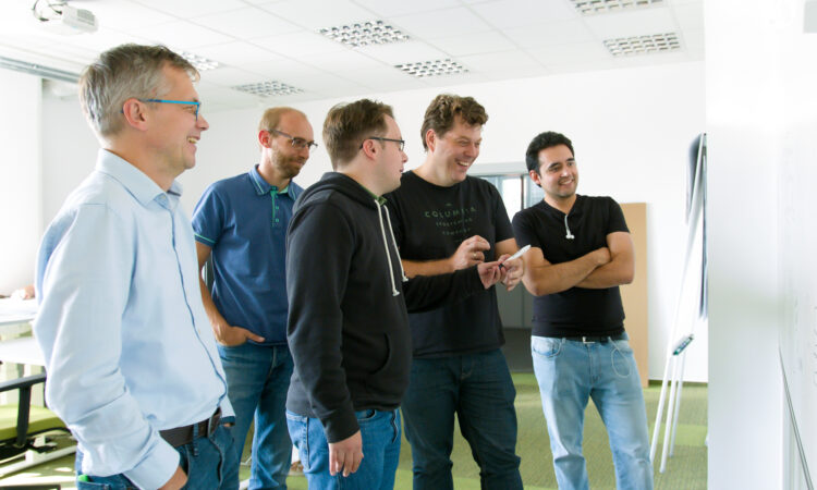 Group of Vendavo Employees Collaborating In office Setting